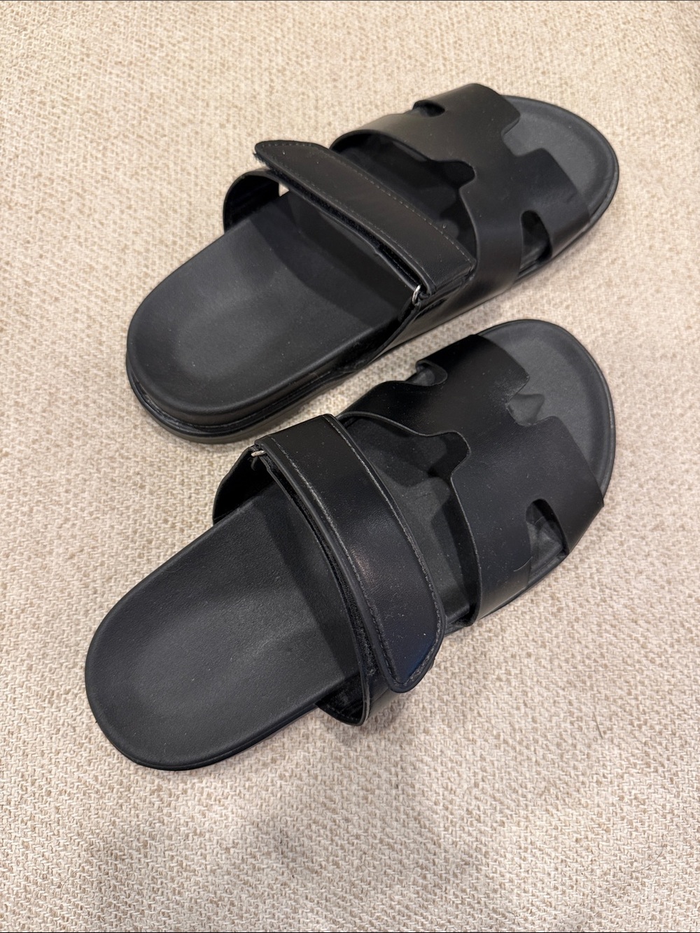 Classic black H-style slide sandals in new, never-worn condition.